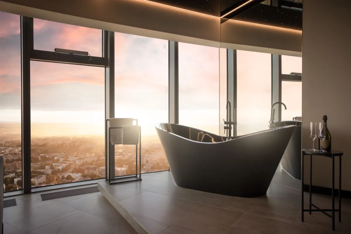 Freestanding bathtub by the panoramic window